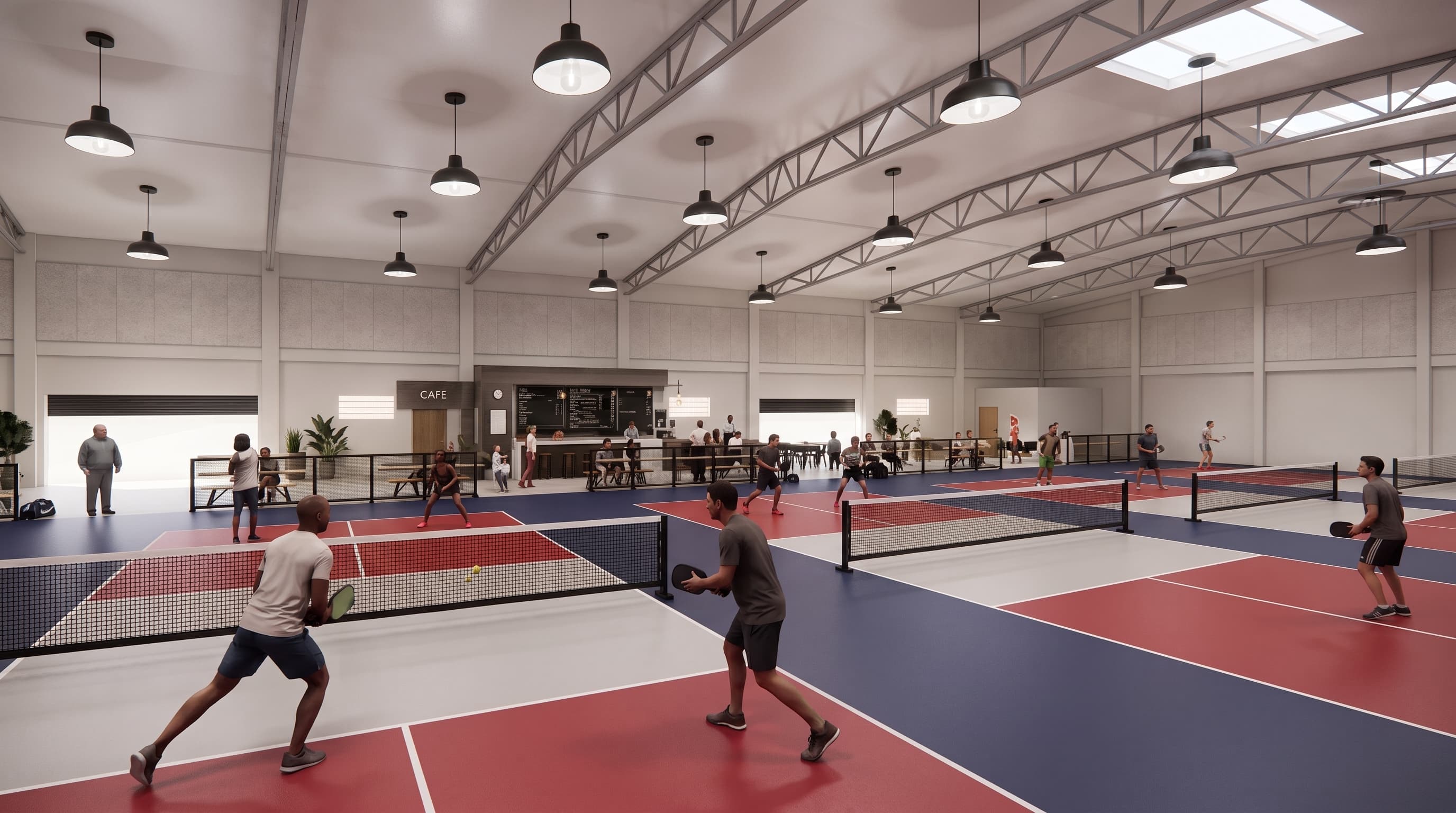 Indoor pickleball courts with players mid-rally